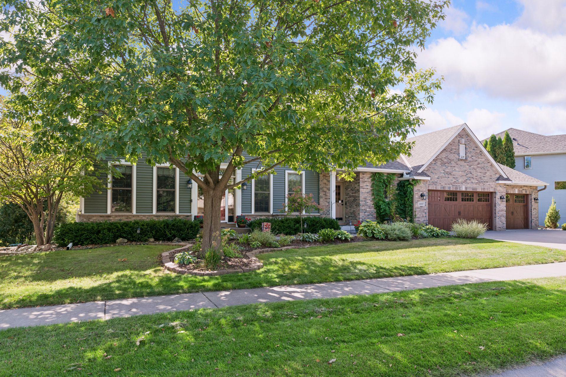 Mature oak, brick front and three-stall garage