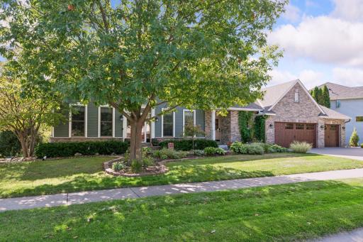 Mature oak, brick front and three-stall garage