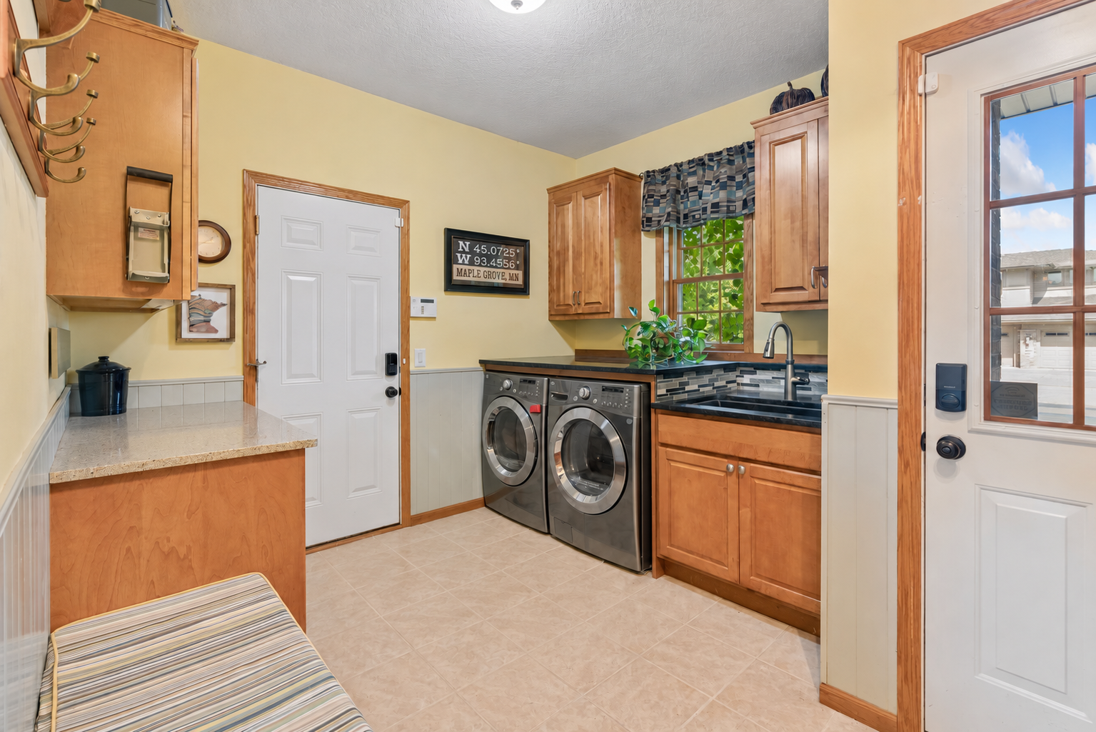 Main-floor laundry with utility sink and folding counter