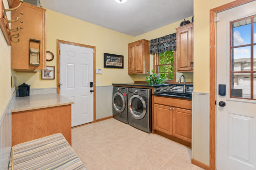 Main-floor laundry with utility sink and folding counter
