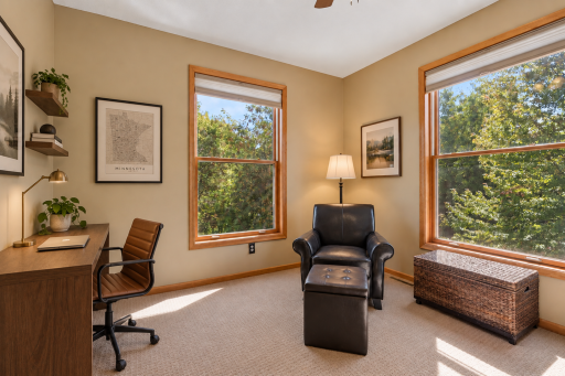 Main-floor office with windows on two walls. Virtually staged