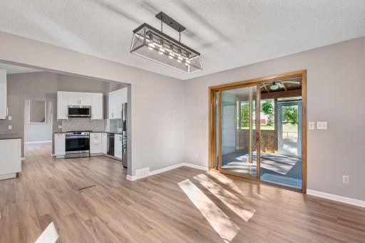 Informal dining into updated kitchen and screen porch