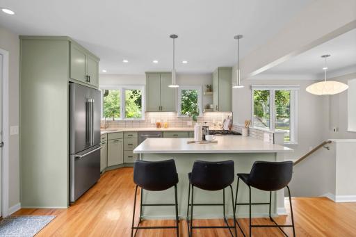 You will love the open kitchen, custom cabinets, quartz counter tops, pendant lighting, under cabinet lighting