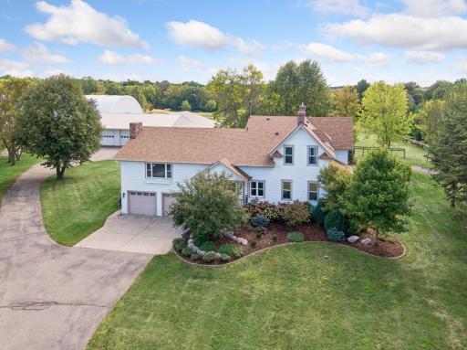 The beautifully maintained farmhouse welcomes you home, surrounded by mature landscaping and peaceful setting of this exceptional acreage.