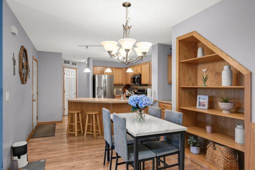 Open Dining area with built-in shelving and breakfast-bar seating nearby.