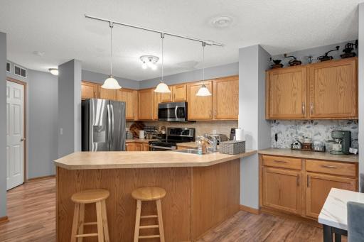 Kitchen offers plenty of cabinetry and counter space plus stainless steel appliances.