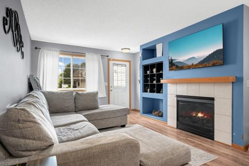 Living Room features newer LVP flooring, a Gas Fireplace and built-in shelving.