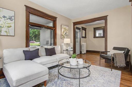 Living room and entryway. Look at the beautiful hardwood floors and woodwork!