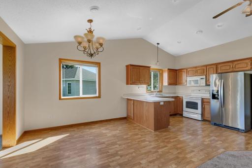 Light and bright with vaulted ceiling, this dining room offers tons of room for bigger gatherings and is open to the 4 season sunroom