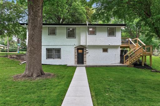 Rear Elevation with wrap around stair case to main level deck (New Deck is adjacent to the Kitchen)