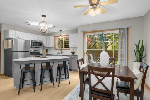 Beautifully updated kitchen with dining area that looks out the sliding door to private backyard.