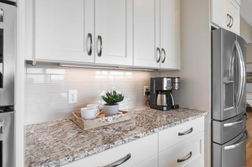 Attention to detail shines throughoutâfrom the crisp cabinetry and under-cabinet lighting to the granite surfaces, tile backsplash, and thoughtfully designed storage.