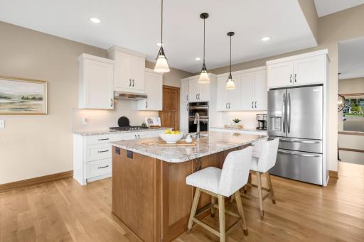 Designed for everyday living and effortless entertaining, this bright kitchen offers abundant cabinetry, generous prep space, and a spacious island that naturally brings everyone together.