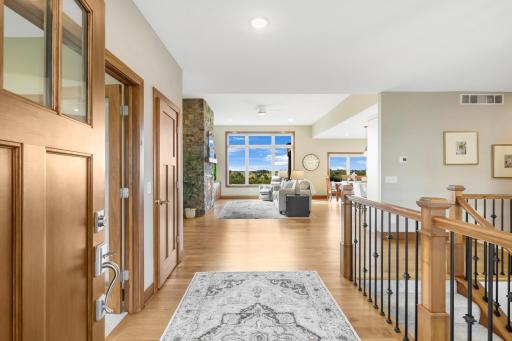 Step inside to a bright, open main level featuring beautiful hardwood floors, warm woodwork, and expansive windows that immediately draw your eye to the views beyond.