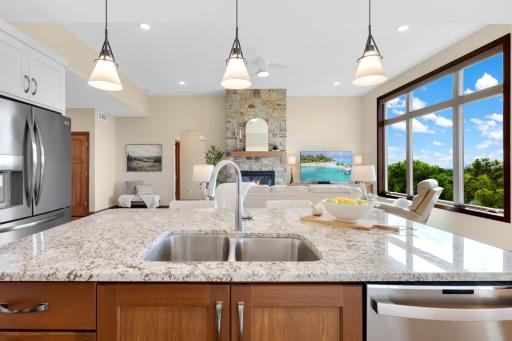 Granite countertops, stainless steel appliances, and an oversized center island combine style and function in this beautifully designed kitchen.