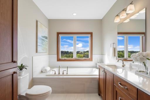 Start and end your day with a viewâthis light-filled primary bath features a relaxing soaking tub, beautiful finishes, and abundant vanity storage.