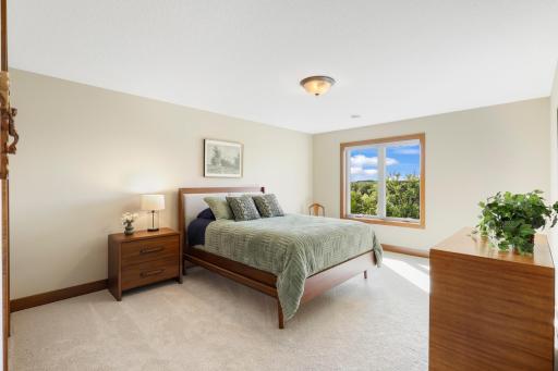 A spacious and inviting third bedroom with abundant natural light, peaceful views and plenty of room for family or overnight guests.