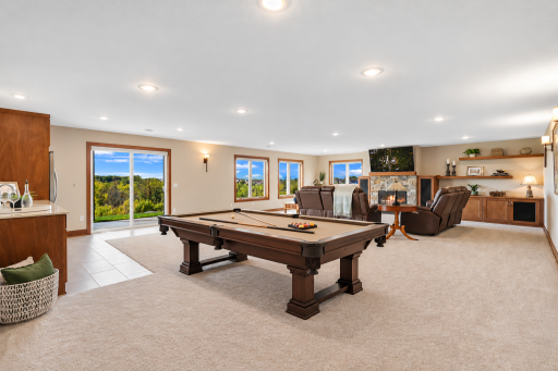 An expansive walkout recreation room brings everyone together with space for billiards, game nights and relaxing by the fireplaceâall while enjoying beautiful views just outside.