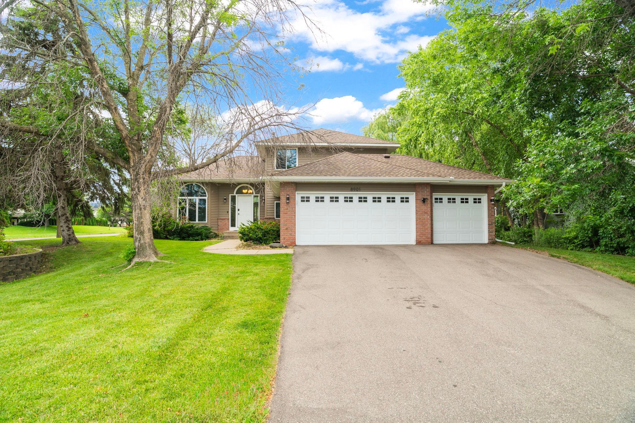 Curb appeal that stops traffic. A sweeping driveway and towering shade trees set the stage for this two story home, ready for its next family to make memories.