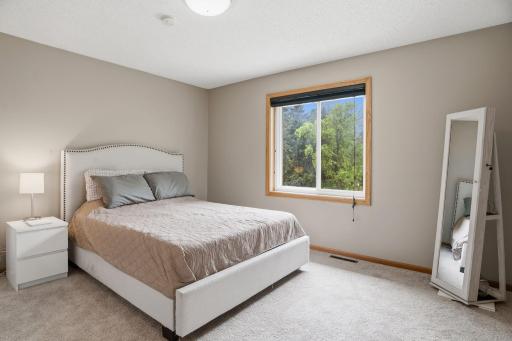 Imagine waking up to treetop views every morning. This upper level bedroom offers soft neutral walls and plush carpet, ready for your own personal touch.