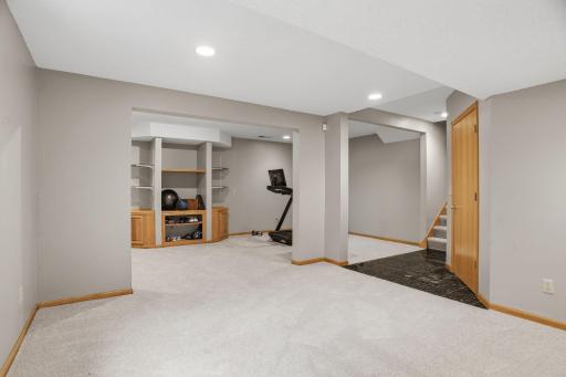 Endless possibilities await in this finished lower level, a built in shelving nook giving buyers room to gather, play, or work out.
