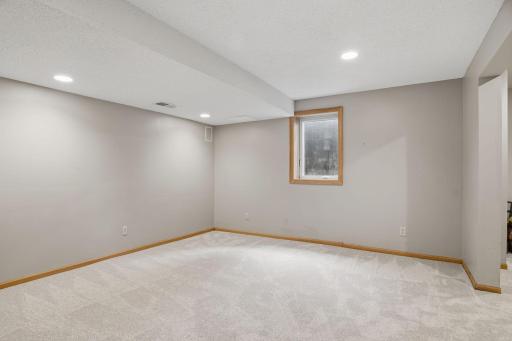 A single window brings daylight into this unfinished corner of the lower level, matching oak trim leaving room for buyers to add their own finishing touch.
