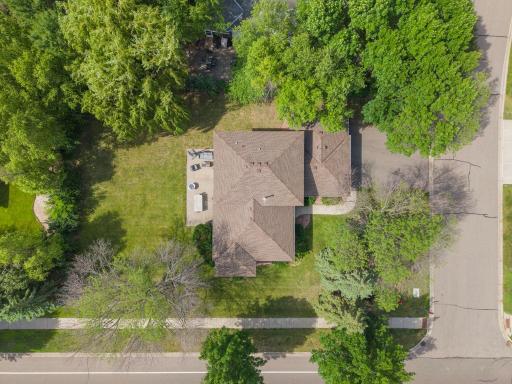 From above, this home's footprint unfolds across a deep, tree bordered lot with privacy and space close to everything you need.