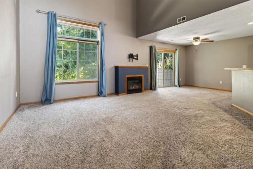 Wide open floor plan with a vaulted ceiling and fireplace.