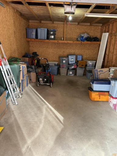 Garage interior sealed from units to the sides and storage available in the rafters