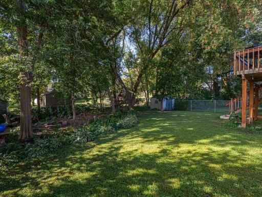 Large fenced in backyard with a fire pit perfect for gathering's