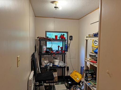 Laundry room with washer and dryer hookup, storage