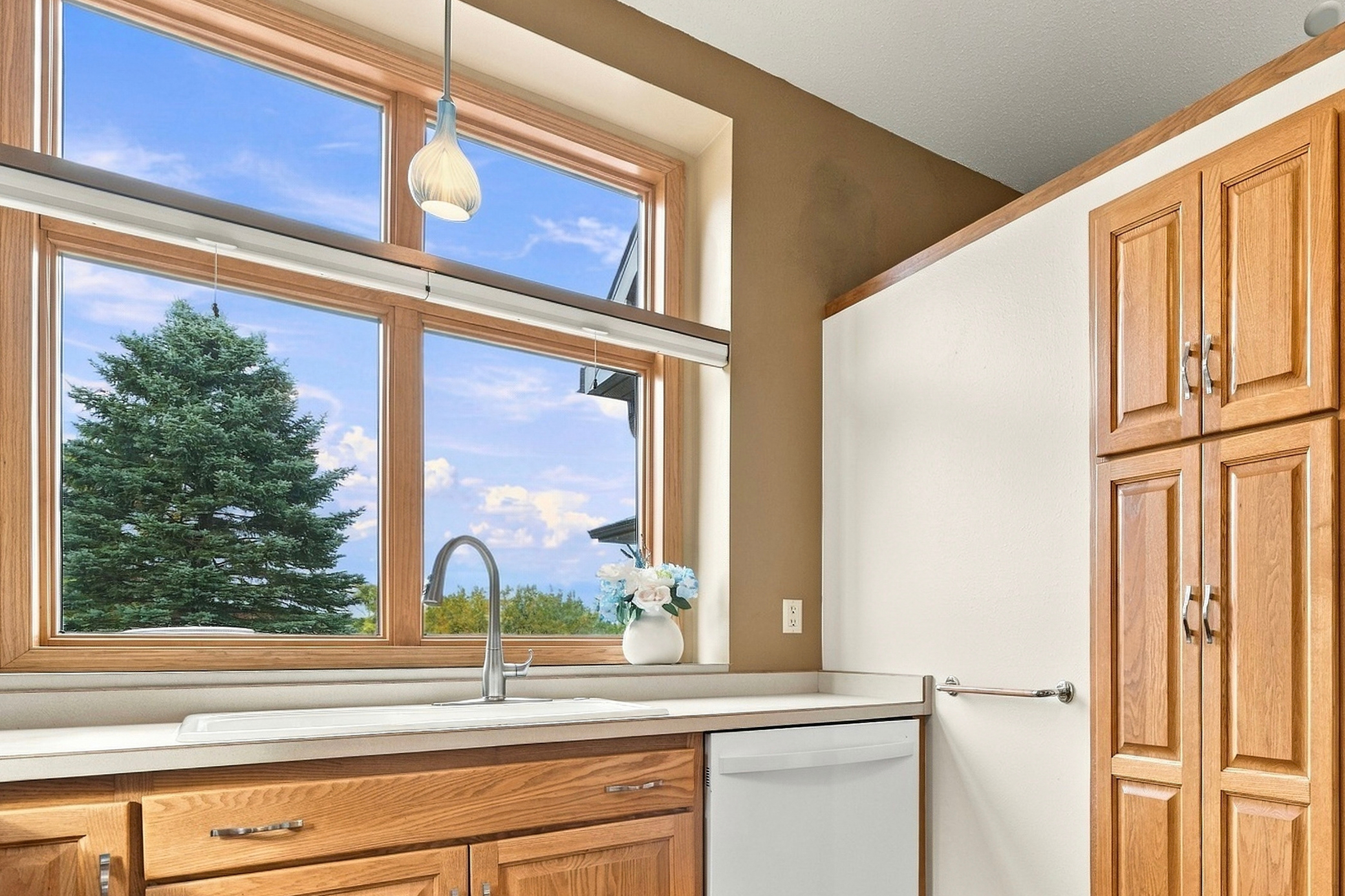 Enjoy a bright and cheerful kitchen enhanced by vaulted ceilings and multiple windows.