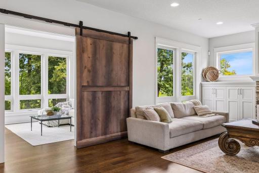 Sliding barn door with access to sunroom.