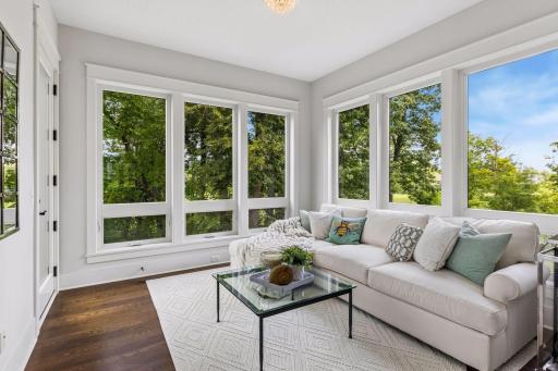 Sun-filled sitting room with wooded views.