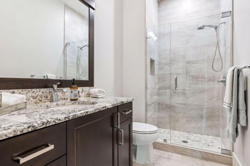 Lower-level guest bath with walk-in shower.