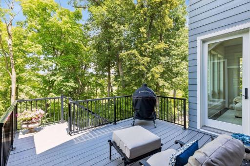 Spacious deck overlooking the wooded backyard.