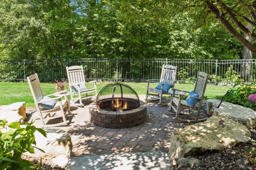 Private fire pit surrounded by mature trees.
