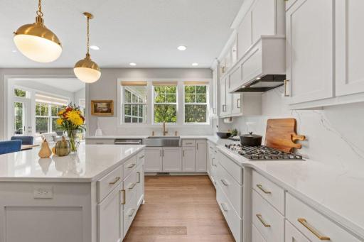 Storage space galore in this custom-designed kitchen. Note the kitchen sink which overlooks the private-wooded backyard.