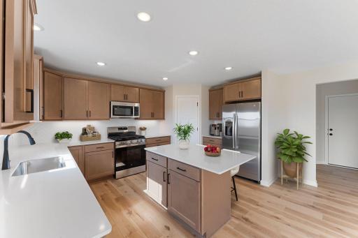Kitchen - center island, all appliances included. Photos are from a staged model and may vary slightly from actual.