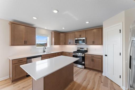 Kitchen has window above sink. Not actual home but similar floorplan.