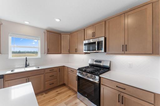 Kitchen with gas range and microwave vented to exterior. Not actual home but similar photos.