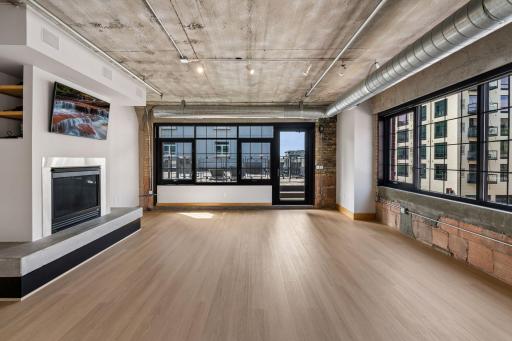 Expansive light-filled living and dining room with new white oak LVP flooring