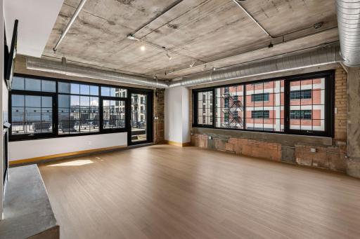 Expansive light-filled living and dining room with new white oak LVP flooring