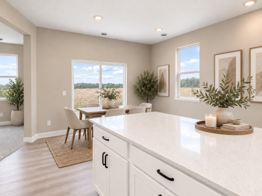 Large island overlooks the LARGE dining room. *Photo of similar home. Virtually staged.