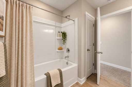 Upper level main full bathroom. *Photo of similar home. Virtually staged.