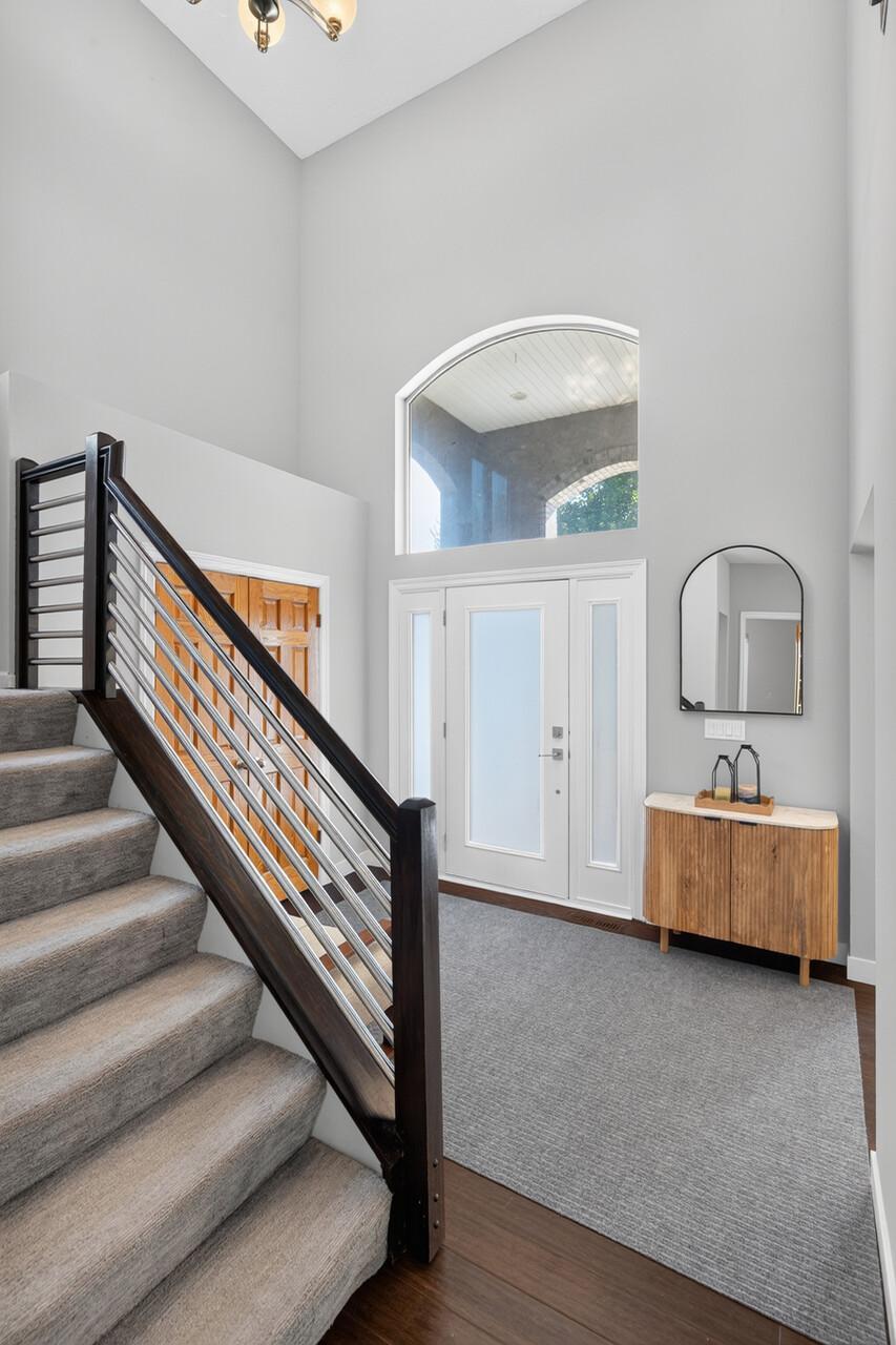 Gorgeous two-story foyer with a beautiful modern staircase.