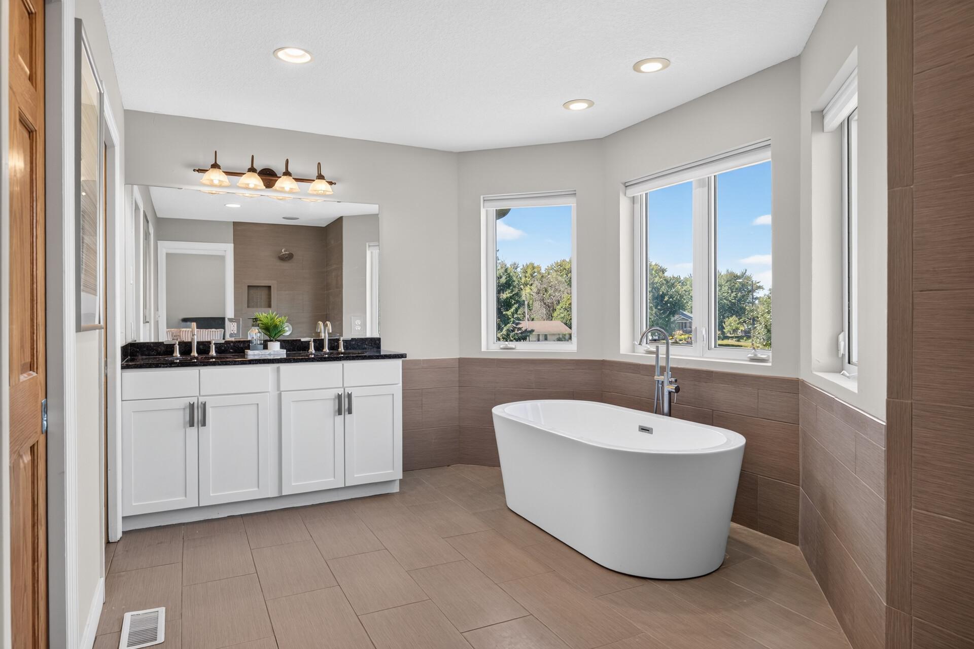 Luxurious primary bath with stand-alone tub and separate shower.