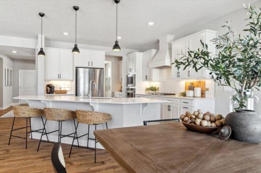 Quartz countertops, stunning backsplash, and more cabinet and counter space than you can imagine! Welcome to the family chef's dream! Model home, color and finish will vary.