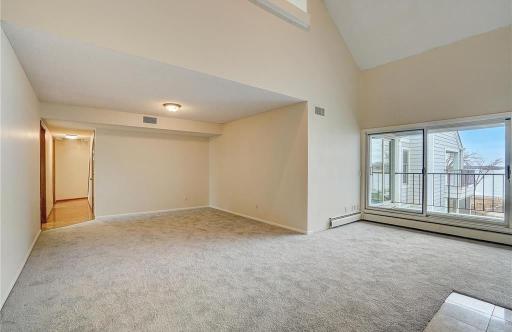 Living room with a vaulted ceiling that opens upward to the loft, creating an airy and connected feel.