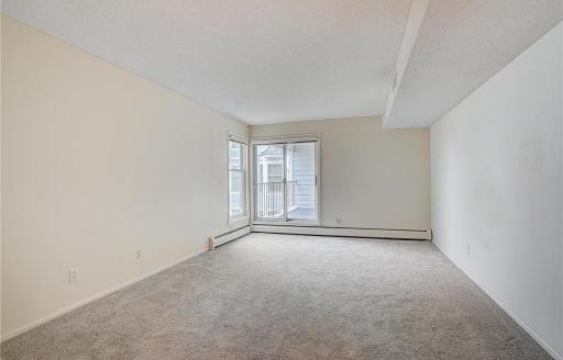 The primary bedroom offers direct access to the balcony and captures serene lake views, creating a peaceful retreat.